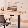Close-up of the electric standing desk's control panel, showcasing anti-collision, position lock, and sedentary reminder features.