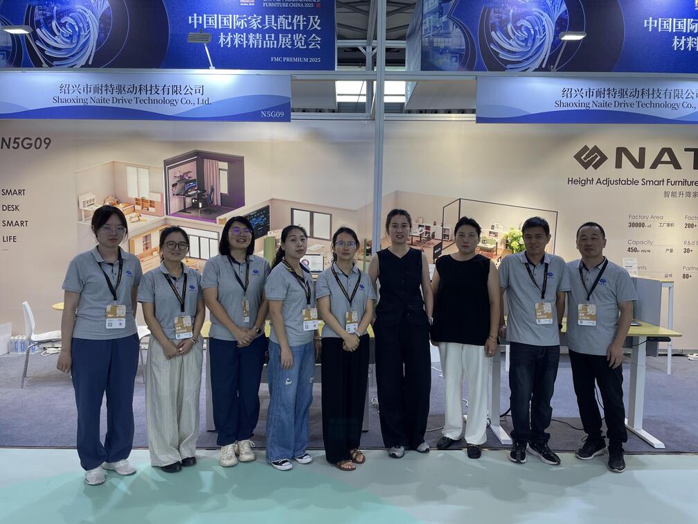The NATE Drive Technology team stands together for a group photo at their booth during the FMC Premium 2025 exhibition in Shanghai.