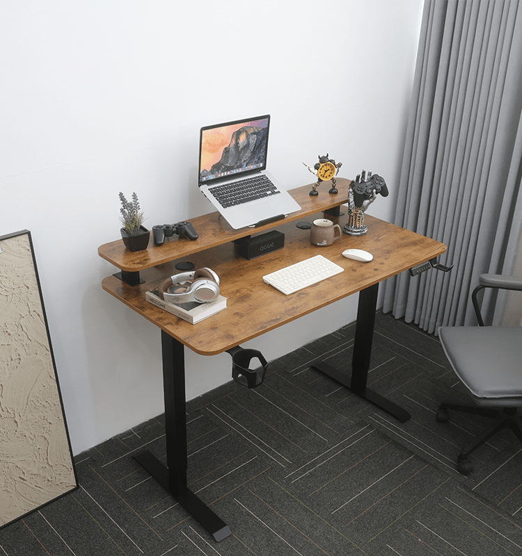 The electric standing desk in a cozy home office setting with a gray chair, showing its versatility and aesthetic appeal in a real-world environment.