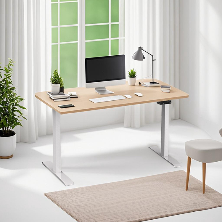 A 2SAB2(F) electric standing desk is shown in a bright, modern home office environment with a light wood desktop and black frame.
