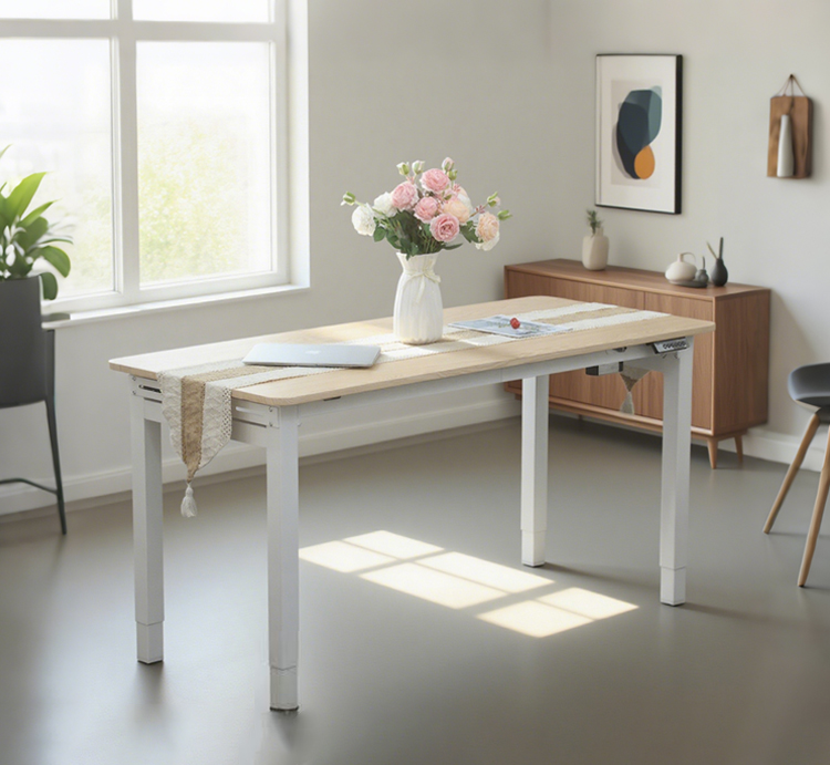 A sleek, light-wood electric adjustable table set for dining in a modern, well-lit room.