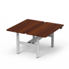 4CF3A dual electric standing desk with rich walnut wood desktops and a white 4-leg frame, configured for a back-to-back workstation.