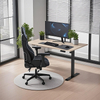  A black height-adjustable desk with a light wood tabletop set up in a home office, complete with a gaming chair, a curved monitor, a keyboard, a mouse, and two small potted plants.