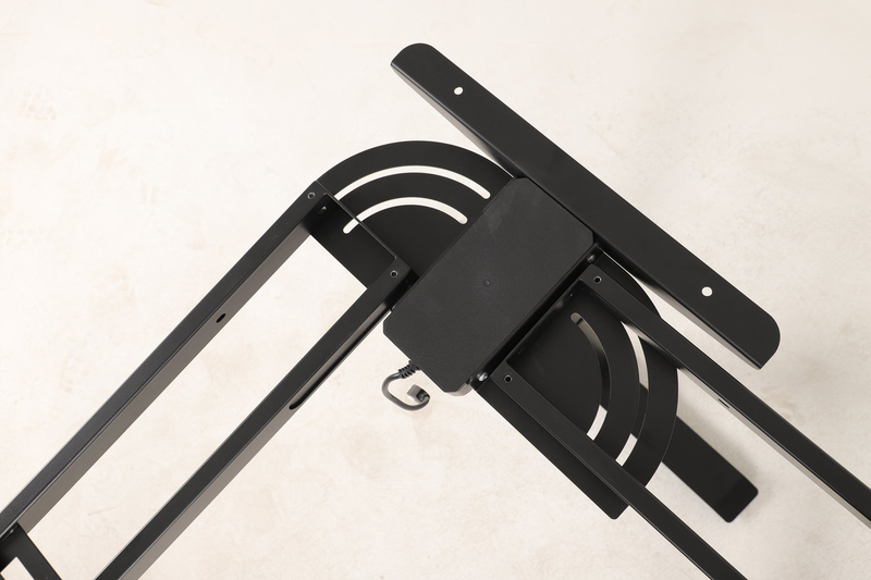 Close-up of the adjustable angle connection on the L-shaped desk frame.