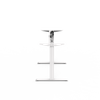 A side profile studio shot of a white, single-motor, height-adjustable desk frame, showing the leg, foot, and motor housing.
