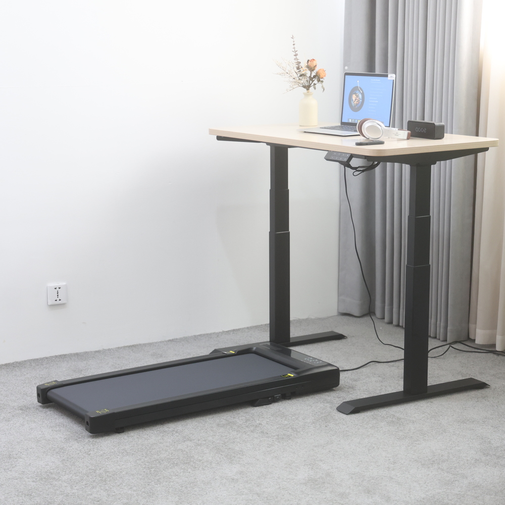 NATE R1 under-desk walking treadmill beside a height-adjustable standing desk