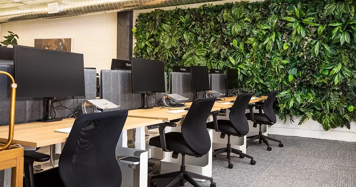 Enterprise office workstation with ergonomic desks, office chairs, monitors and collaborative workspace layout