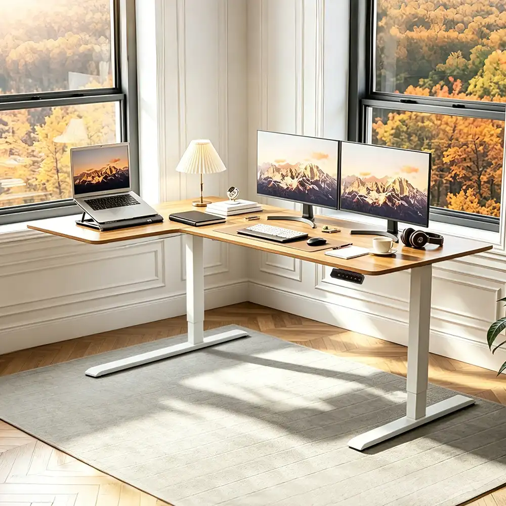 White L-shaped standing desk frame with tabletop scene